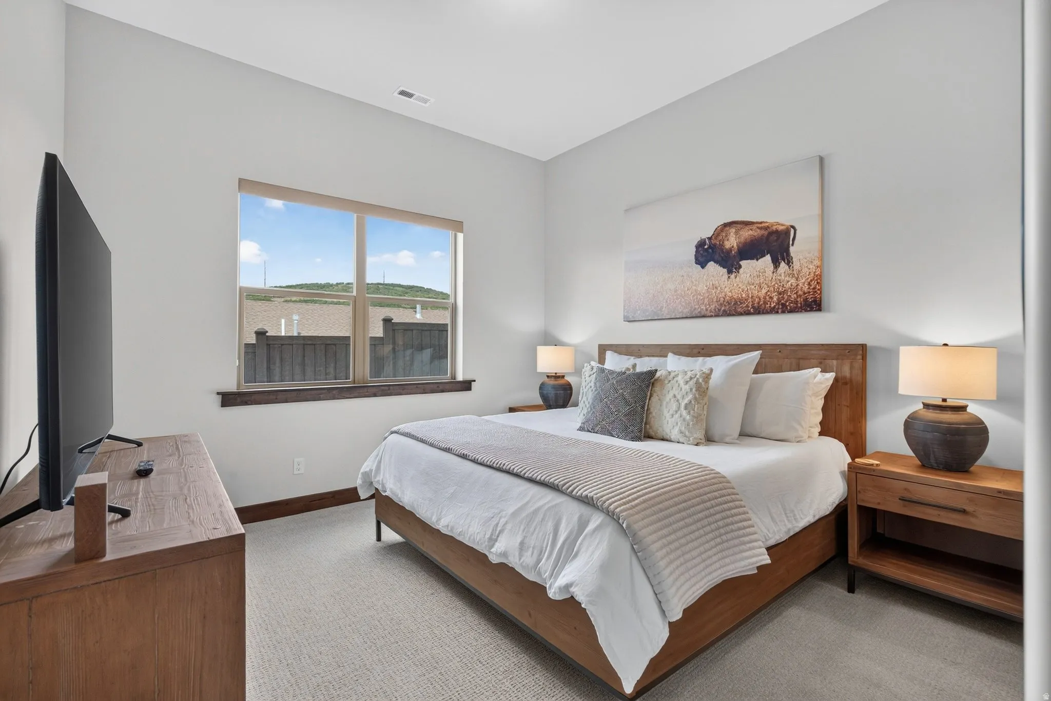 Hardwood window trim, light-toned wall paint, and light-toned carpet flooring