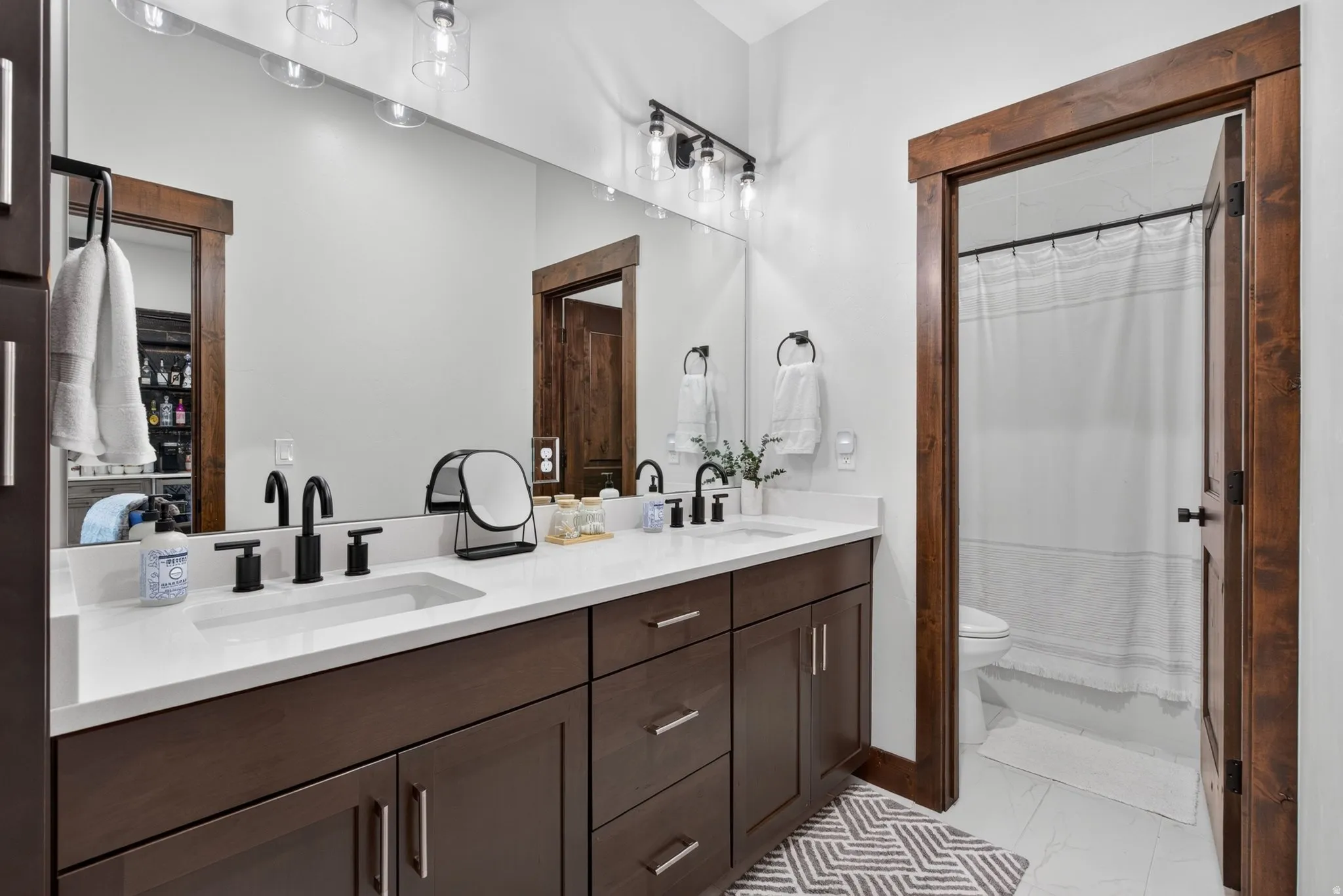 Dual vanity with white countertops and undermount sinks