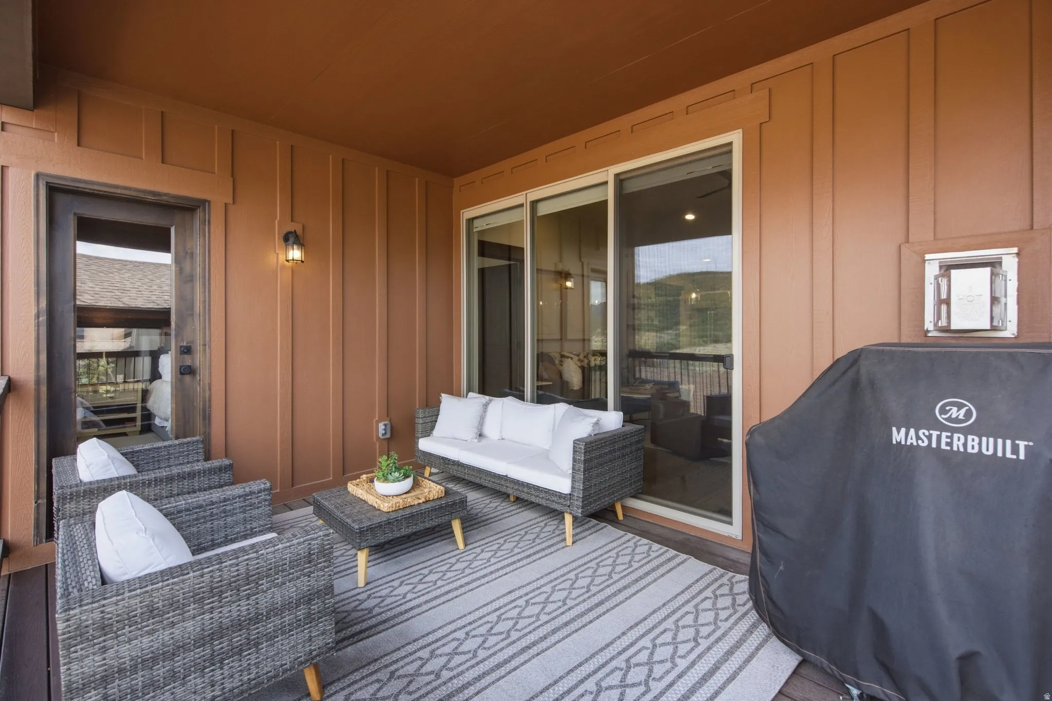 Covered patio with durable composite decking and board and batten siding