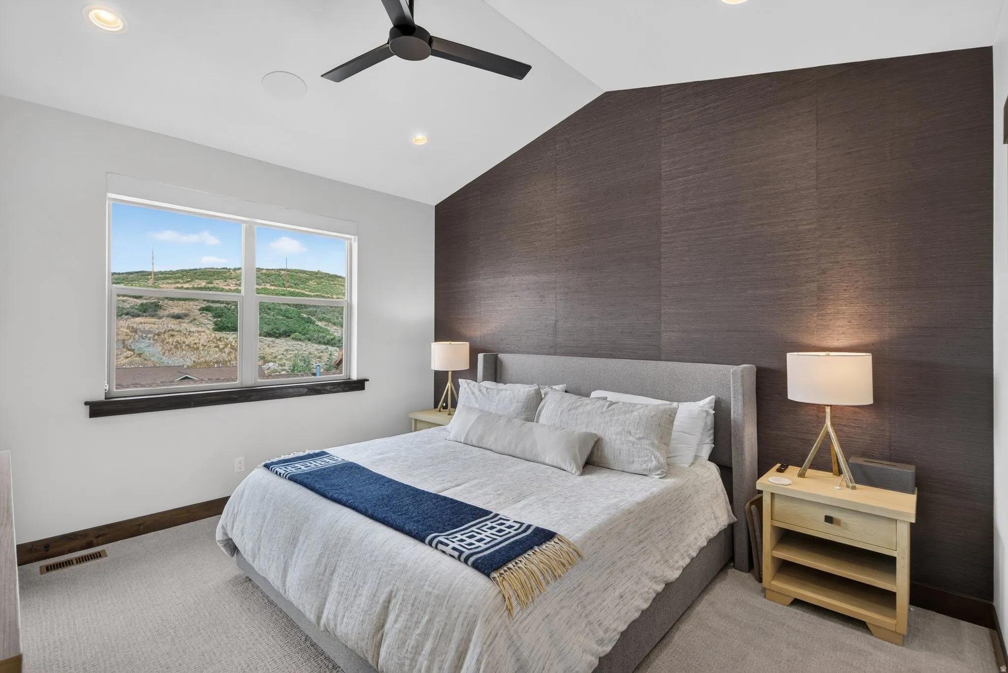 Vaulted ceiling with recessed lighting and ceiling fan