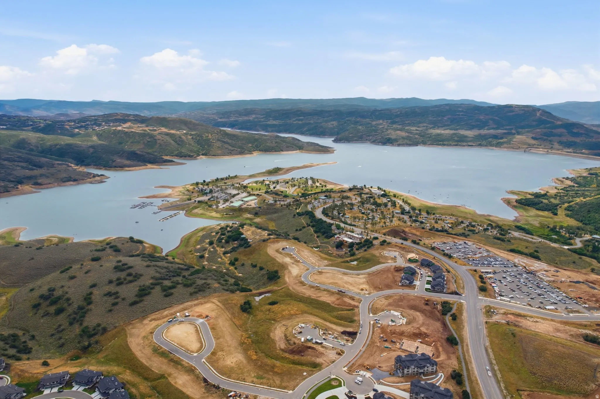 Expansive lake frontage with a marina and surrounding mountainous terrain