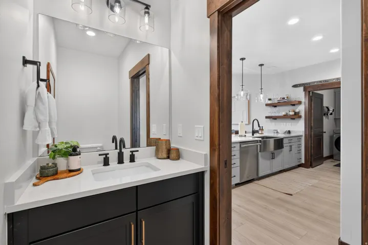 Bathroom vanity featuring a rectangular undermount sink, matte black faucet, and a quartz countertop