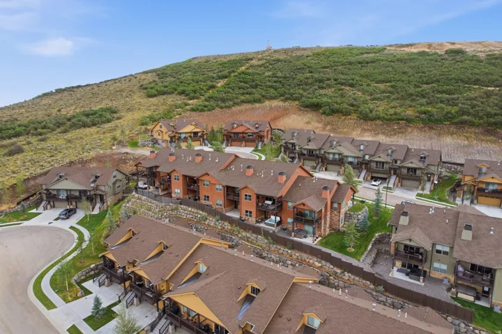 Hillside community featuring multiple residential structures with varied architectural styles