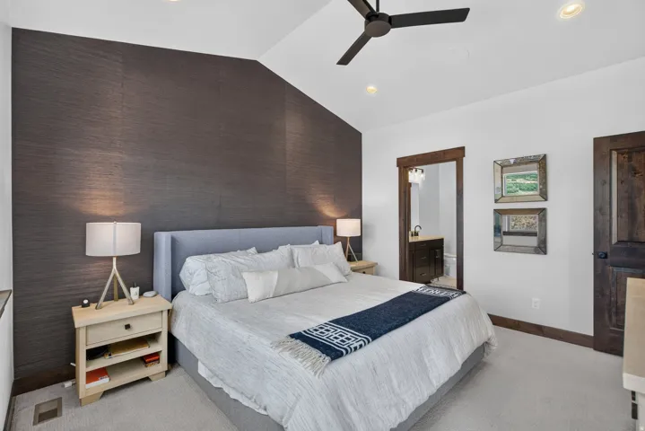Vaulted ceiling with recessed lighting and a ceiling fan