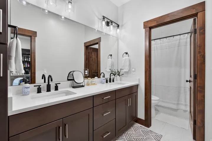 Dual vanity with white countertops and undermount sinks