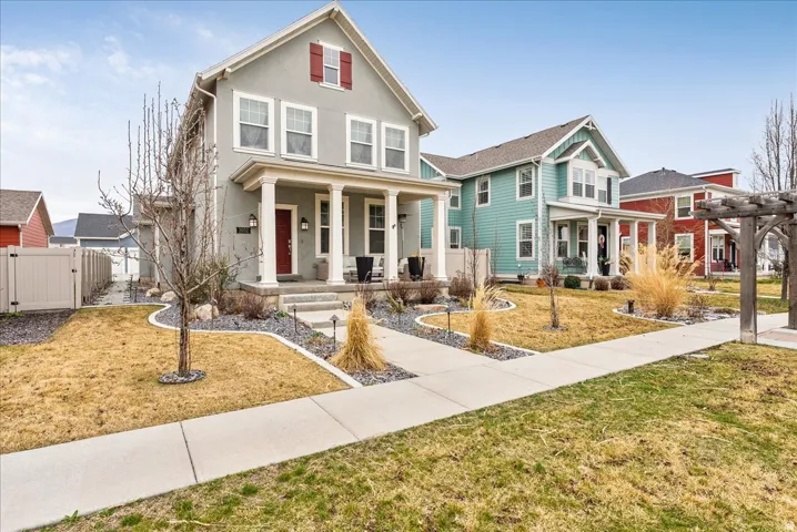 Gray exterior with white trim, red accent shutters, and a red front door