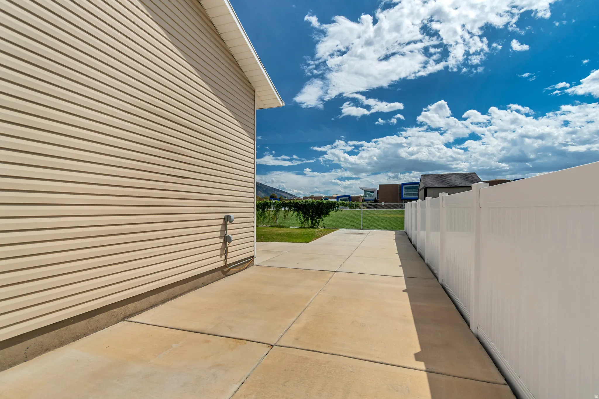 Exterior featuring horizontal siding, concrete foundation, and an expansive concrete patio