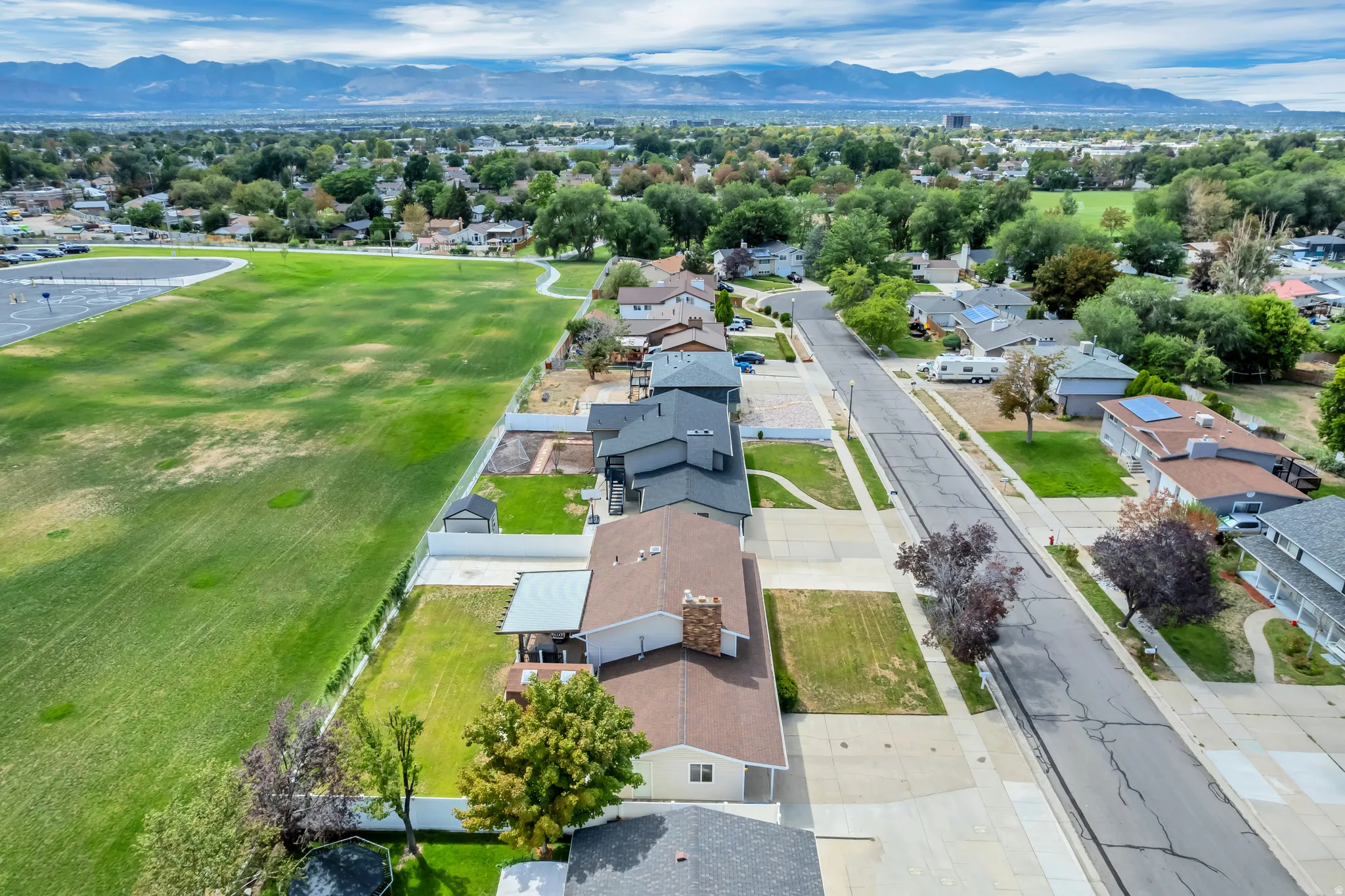 Residential area with a street, sidewalks, and established landscaping