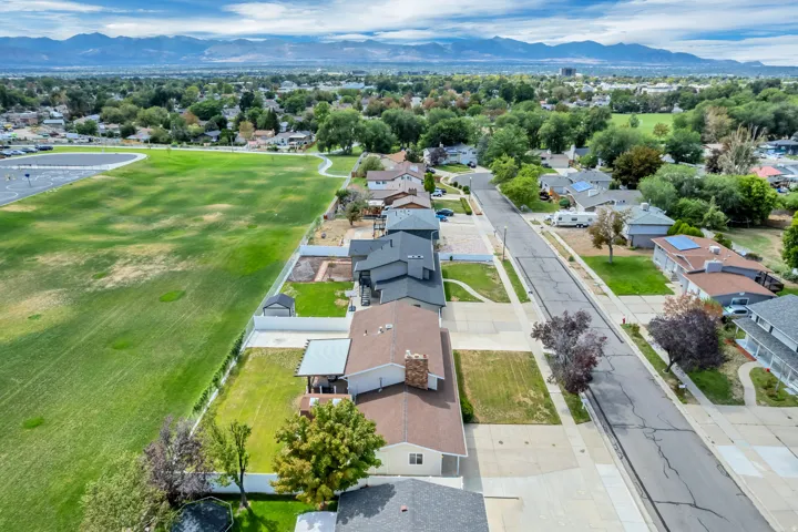 Residential area with a street, sidewalks, and established landscaping