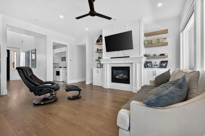 Spacious living area featuring wood-finish flooring, recessed lighting, and a ceiling fan