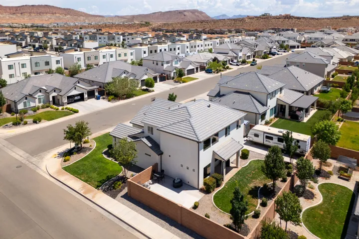 Corner lot residence featuring a two-story design, stucco exterior, and a tiled roof