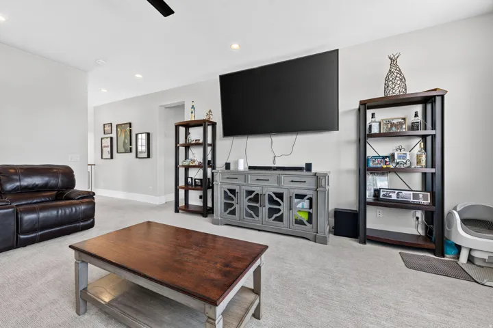 Recessed lighting, light-colored walls, and a ceiling fan