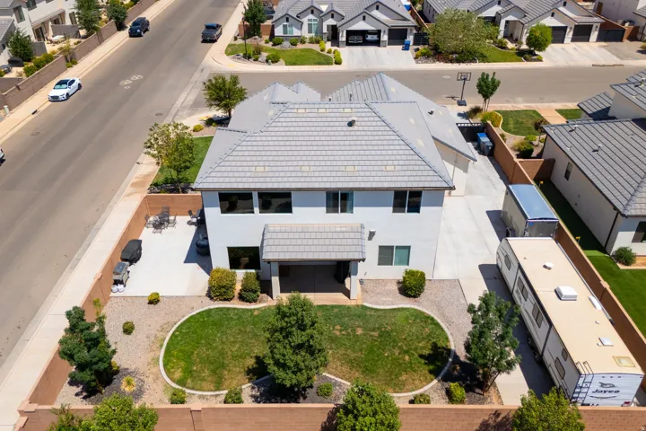 Two-story residence with a gray tile roof and a covered patio
