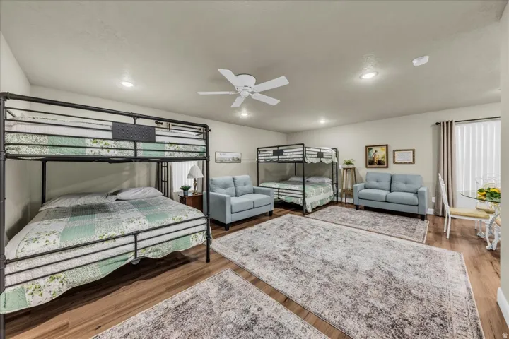 Recessed lighting, wood-finish flooring, and a ceiling fan