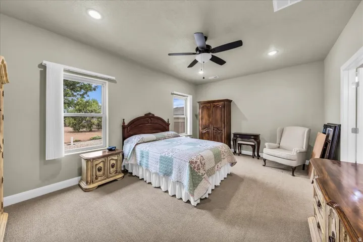 Carpeted room with recessed lighting and a ceiling fan
