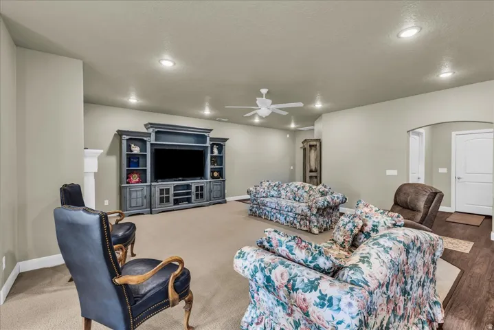 Spacious living area featuring recessed lighting, a ceiling fan, and a built-in entertainment center