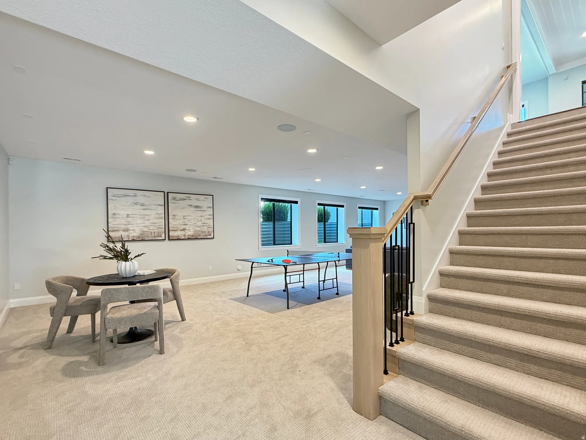 Spacious lower level featuring recessed lighting, a neutral carpeted floor, and multiple windows