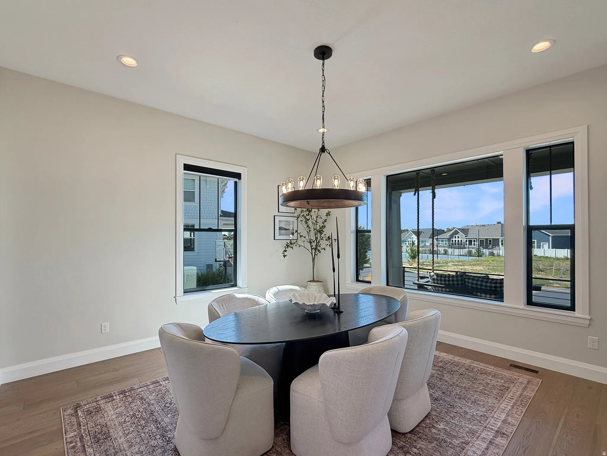 Recessed ceiling lighting complements a contemporary chandelier