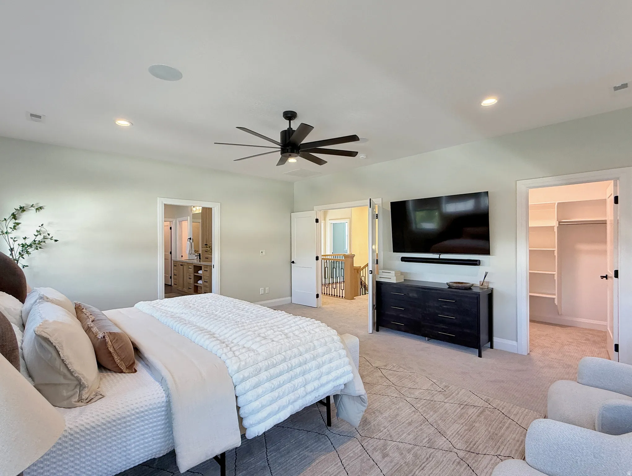 Recessed lighting, ceiling fan, and carpeted flooring