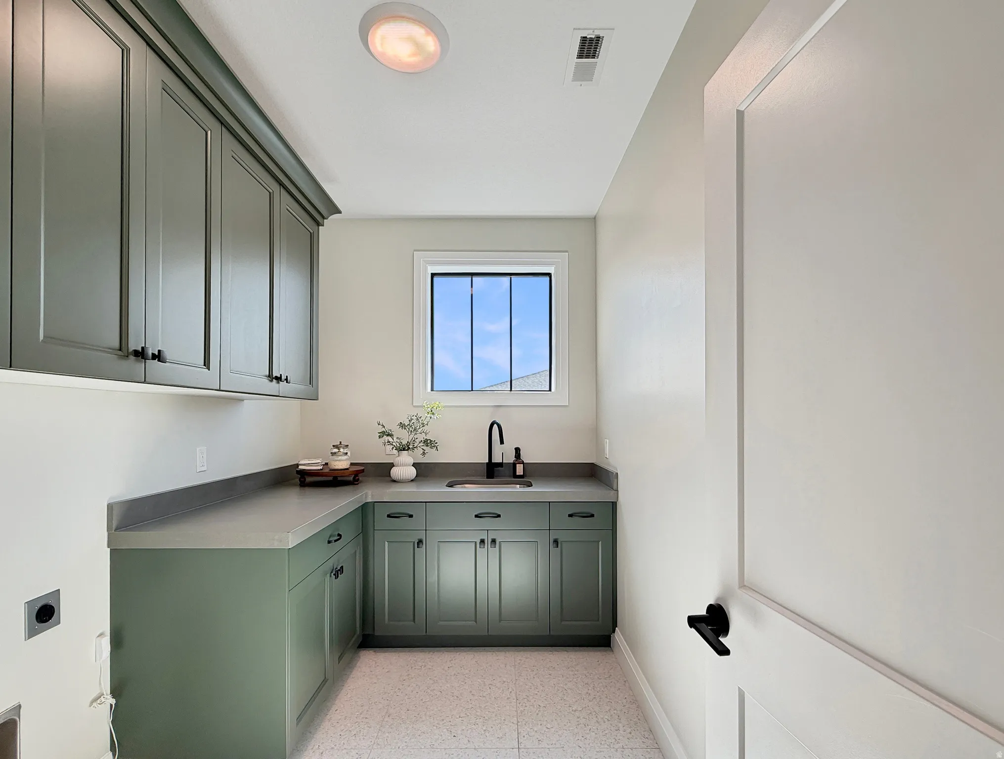 Built-in cabinetry with ample storage, integrated sink, and durable countertop