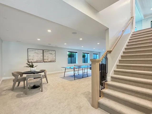 Spacious lower level featuring recessed lighting, a neutral carpeted floor, and multiple windows