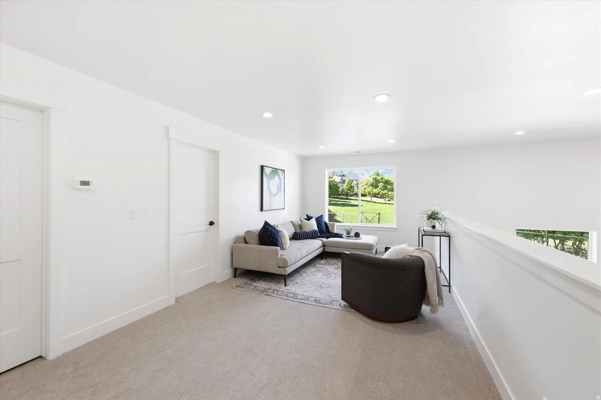Carpeted flooring, recessed lighting, white interior doors, and a window with exterior landscape