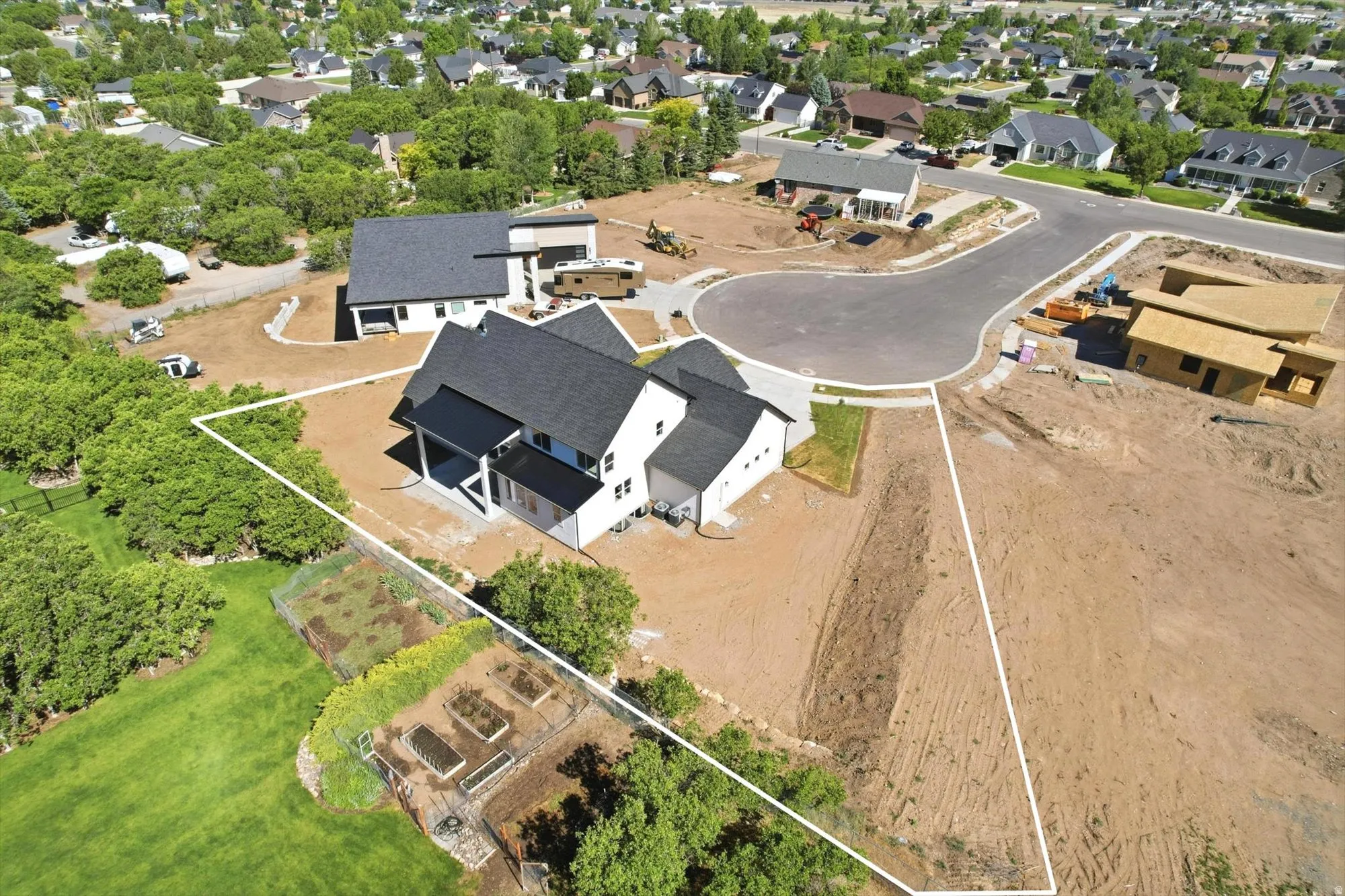 Newly constructed property with a modern facade, dark-pitched roof, and white siding