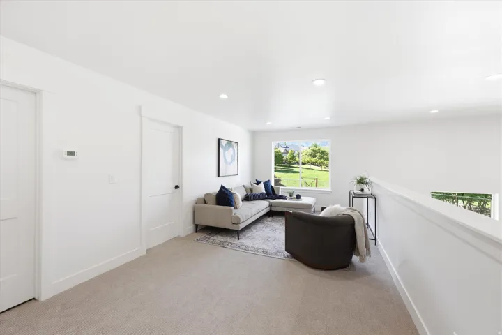 Carpeted flooring, recessed lighting, white interior doors, and a window with exterior landscape