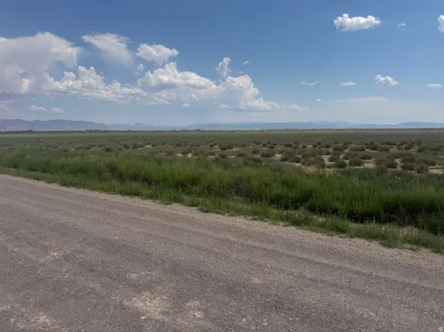 Expansive open terrain with natural vegetation and distant mountain ranges