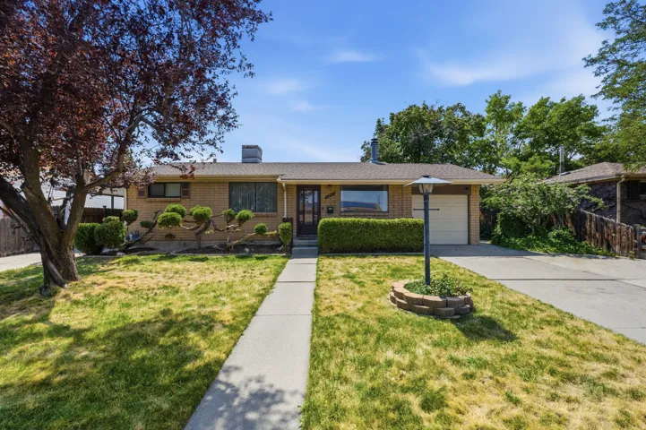 Brick exterior with a single-car garage and a paved driveway