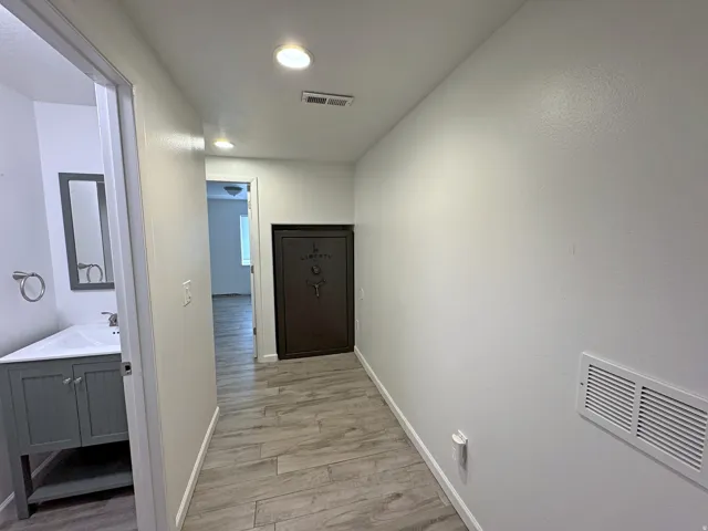 Light wood-finish flooring with recessed lighting
