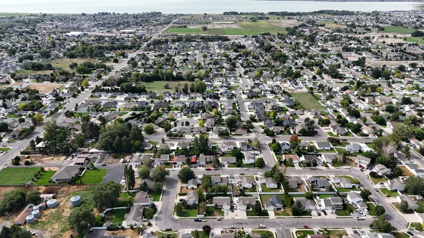Established residential area with mature trees and a distant body of water