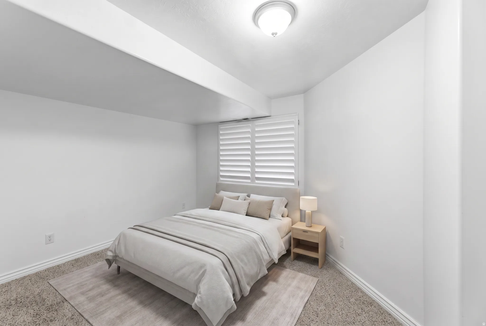 Recessed window with white plantation shutters, overhead flush-mount lighting, and neutral-toned wall-to-wall carpeting
