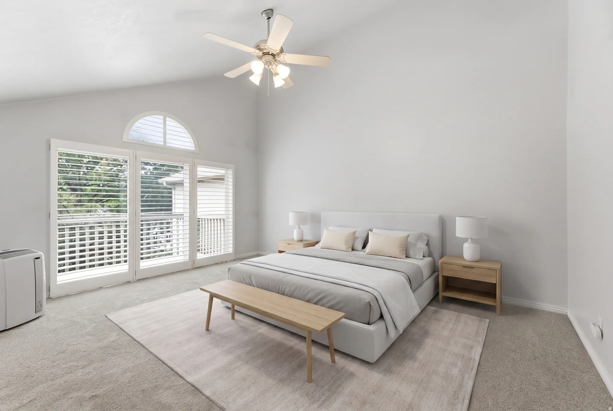 Vaulted ceiling with a ceiling fan, arched transom window, French doors with white shutters, and neutral-toned carpeting