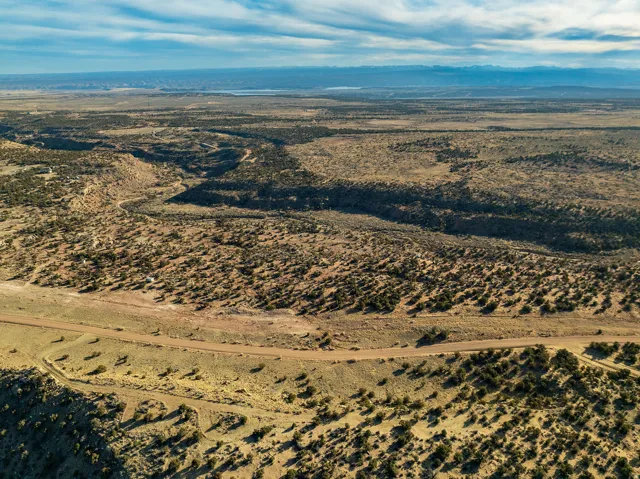 Expansive desert landscape featuring natural terrain and distant mountains