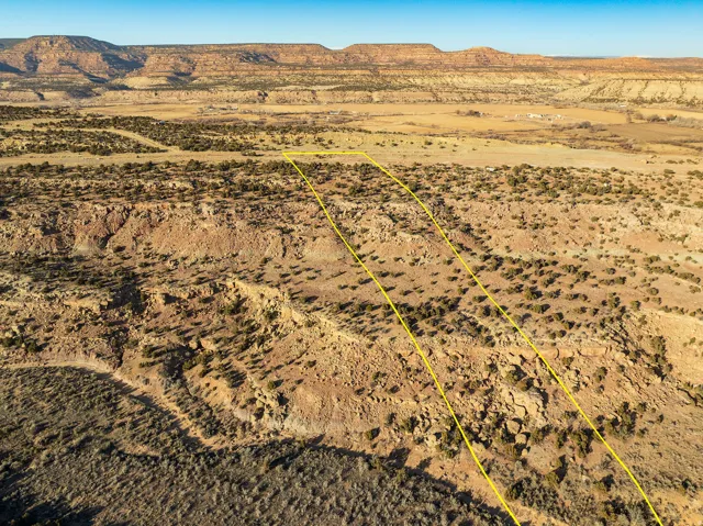 Expansive desert landscape with natural rock formations and distant mountain ranges