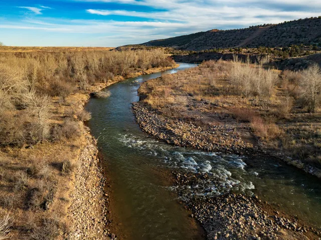 Nearby Duchesne River featuring a winding river, rocky banks, and expansive natural landscape
