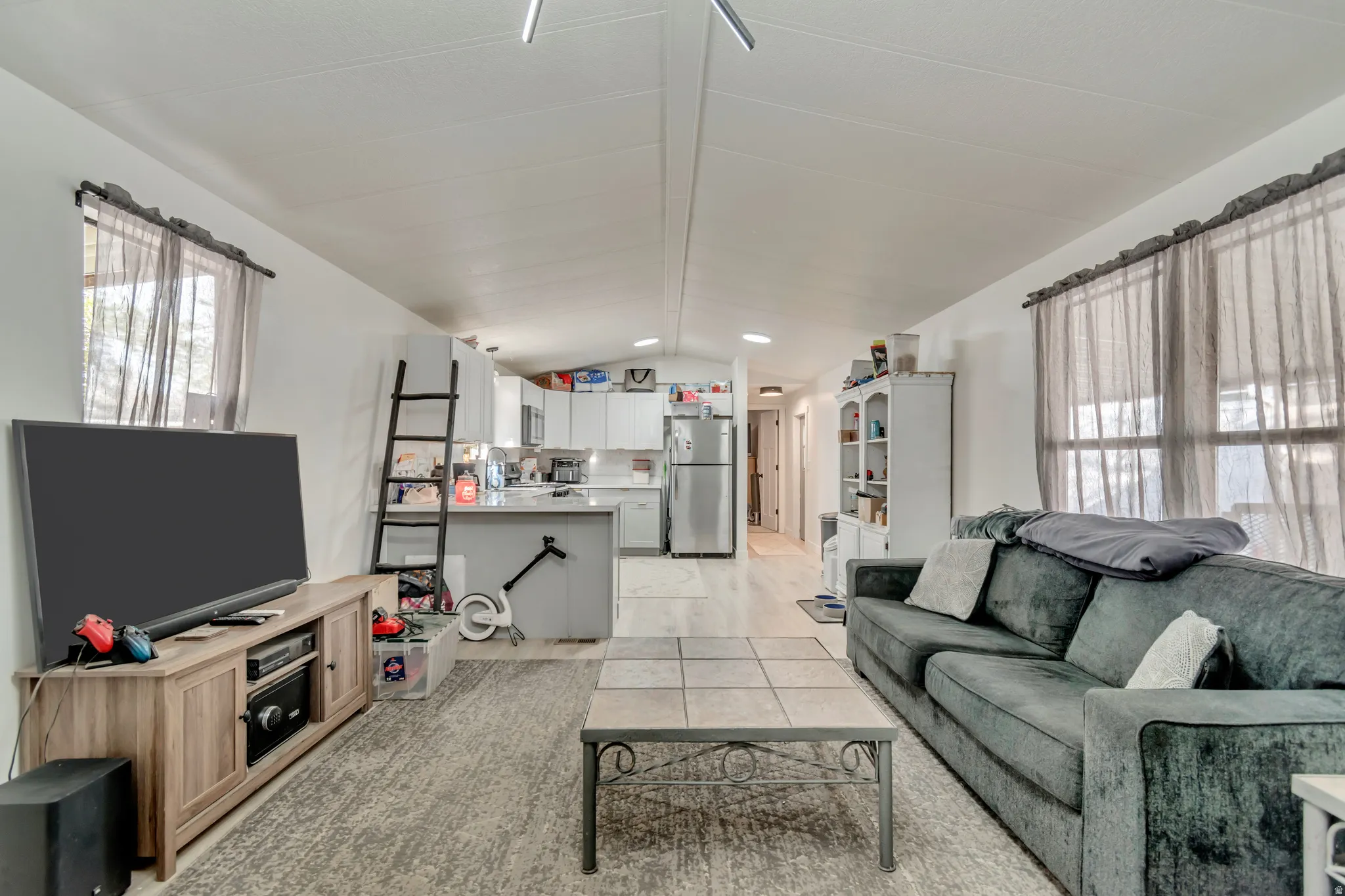 Open-concept living space with light-toned wood-finish flooring