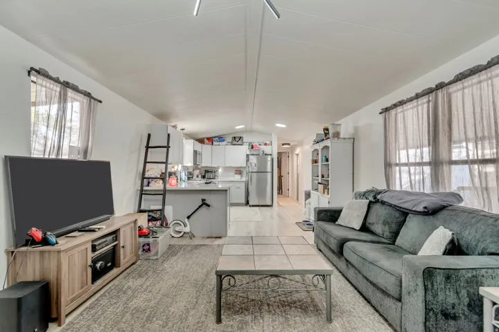 Open-concept living space with light-toned wood-finish flooring