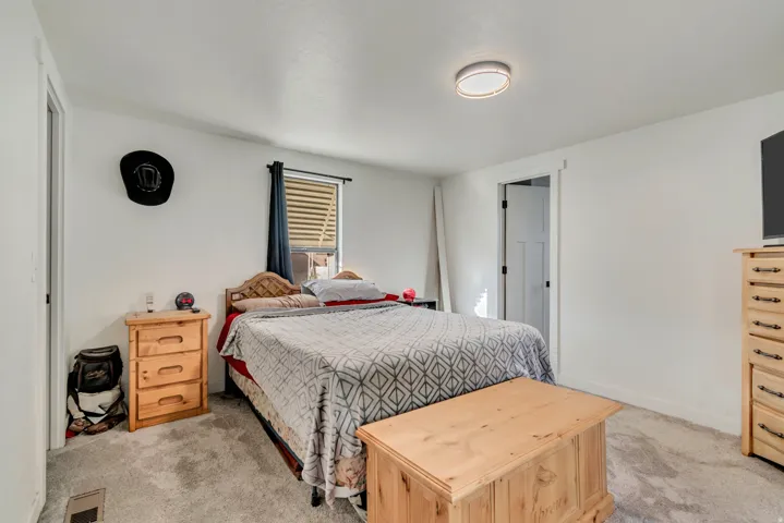 White walls, flush-mount ceiling light, and a window with blinds