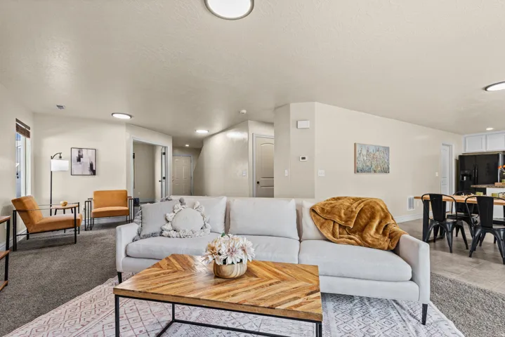Recessed lighting illuminates neutral-toned walls and plush carpeting