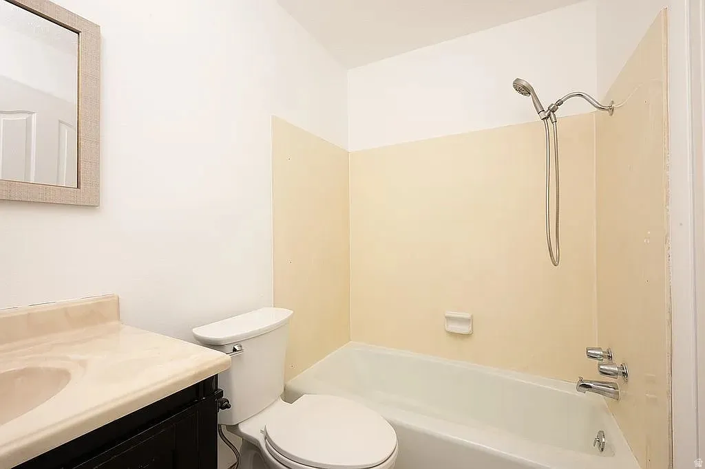 Built-in bathtub with a wall-mounted showerhead and polished chrome fixtures
