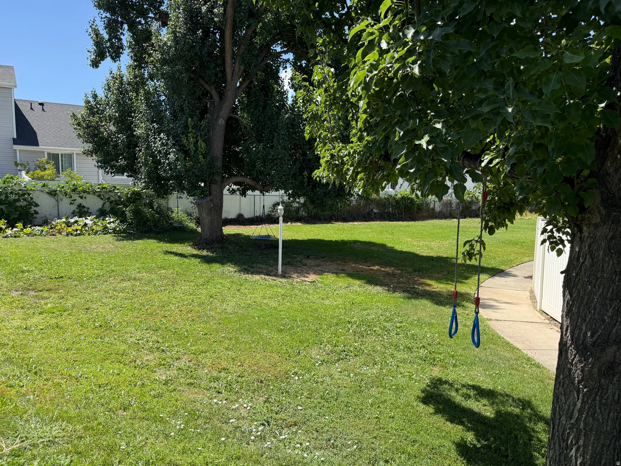 Community play area behind the gate in the backyard of the property.