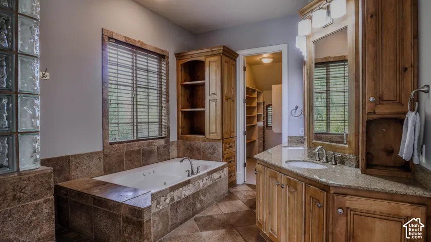 Primary bathroom with separate tub/shower & large walk-in closet