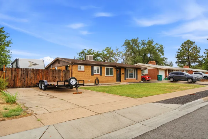 Charming wood-finish exterior with updated siding and multiple windows flooding the interior with natural light