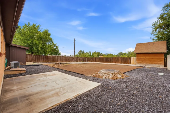 Brick ranch home featuring a spacious front lawn with single-car driveway and RV parking
