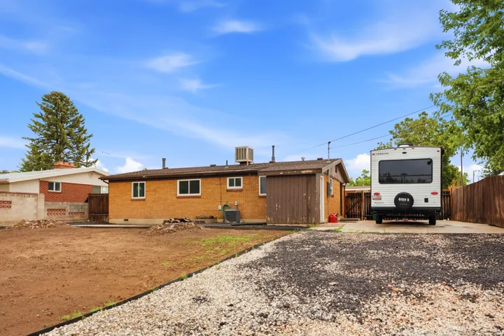 Brick residence with expansive grounds featuring newly seeded backyard, storage shed, and RV parking