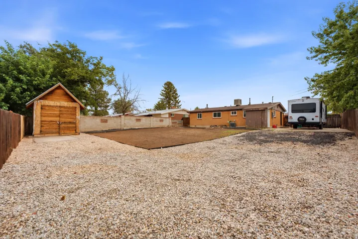 Brick residence with expansive grounds featuring newly seeded backyard, storage shed, and RV parking