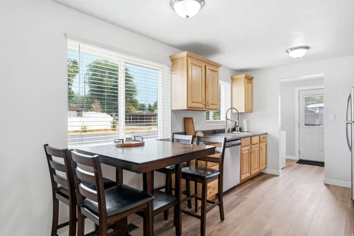 Bright kitchen featuring wood-finish cabinetry, stainless steel appliances