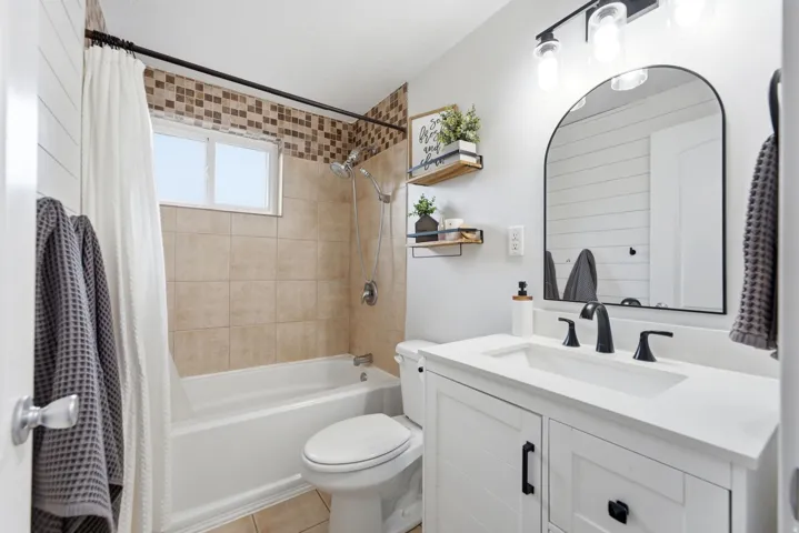 White shaker-style vanity with a light-toned countertop